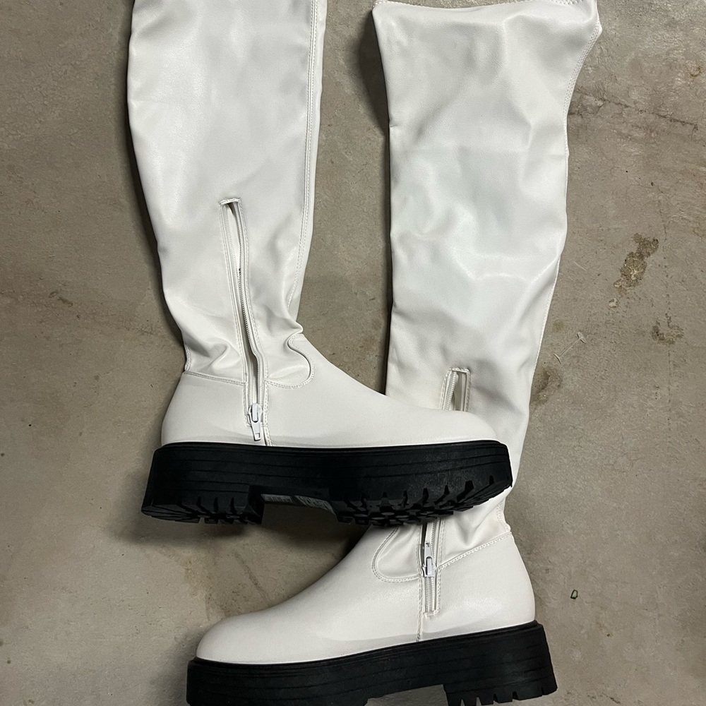 Over the knee flat moto-style boots.
